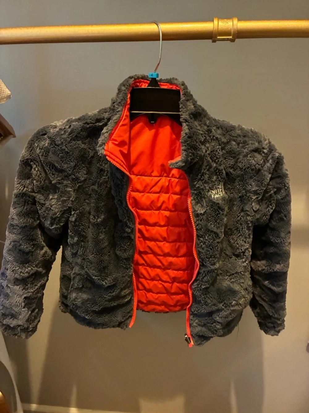 The North Face reversible Kids coral Jacket with Charcoal Fleece Interior.